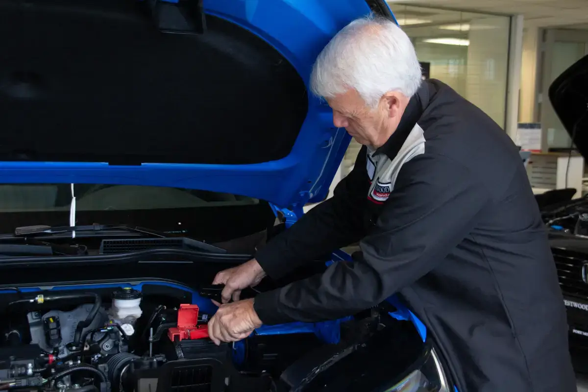 Experienced car technician performing engine check at WestWoodHonda Experienced car technician performing engine check at WestWoodHonda
