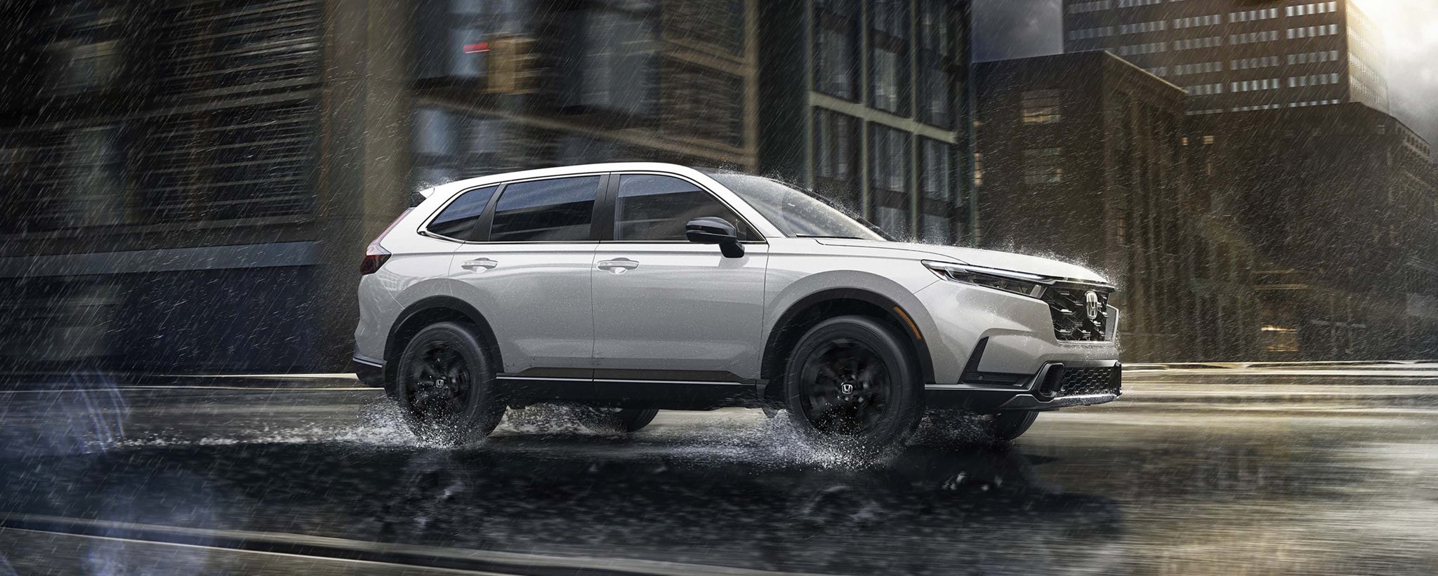 2027 Honda CR-V side view driving through rain on a city street